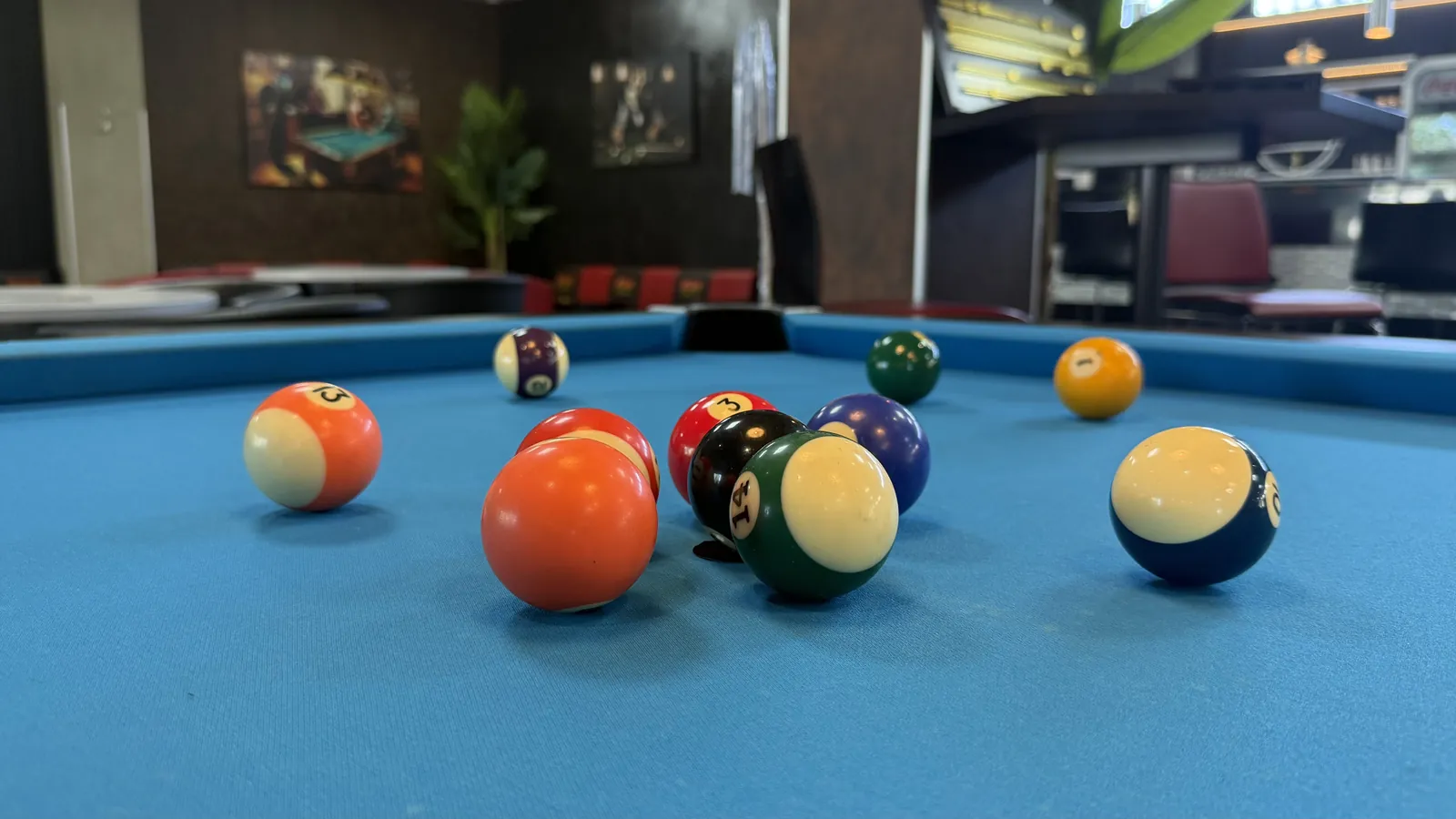 Aufgebaute Kugeln auf dem blauen Tuch eines Pooltischs in der Players Lounge Voerde